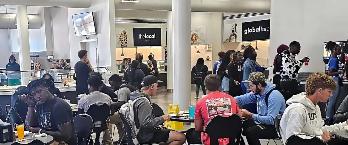 Students at tables eating in dining hall