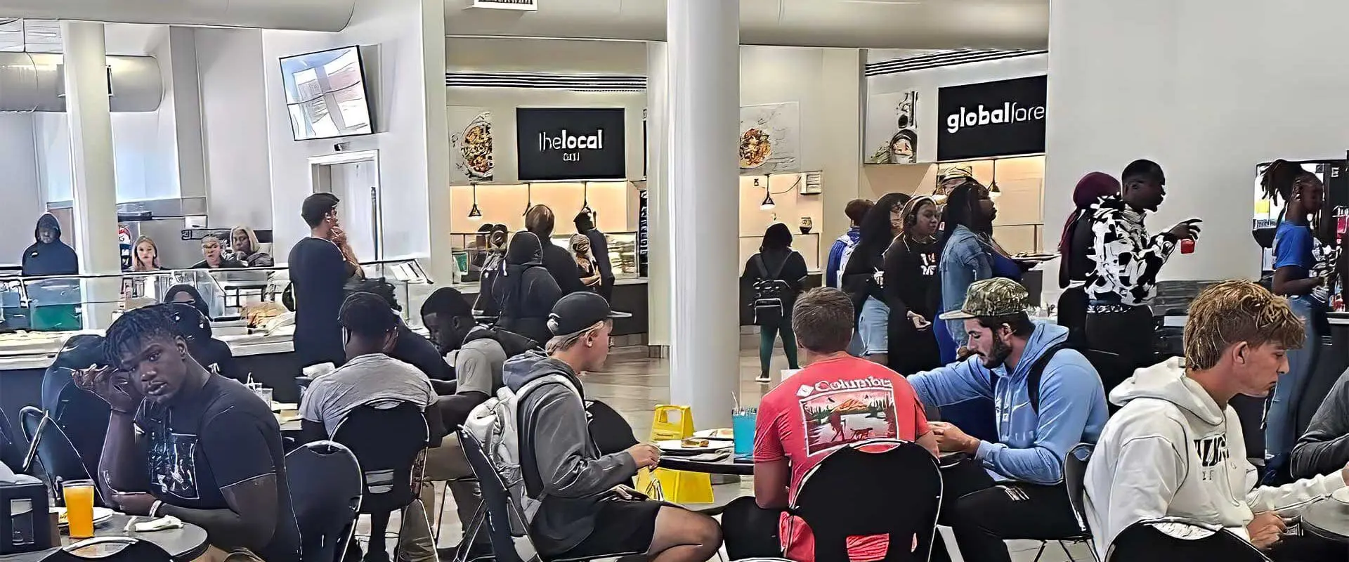 Students at tables eating in dining hall