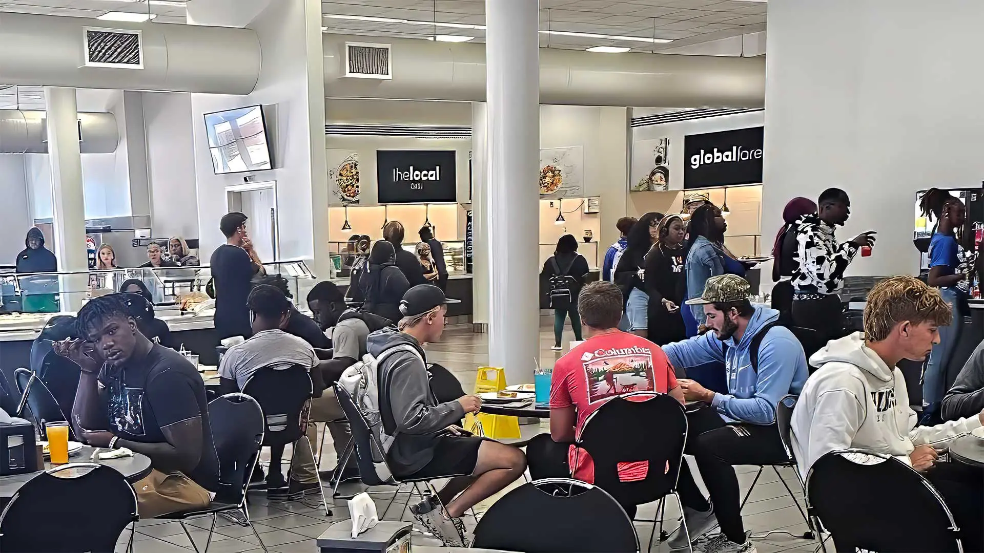 Students at tables eating in dining hall