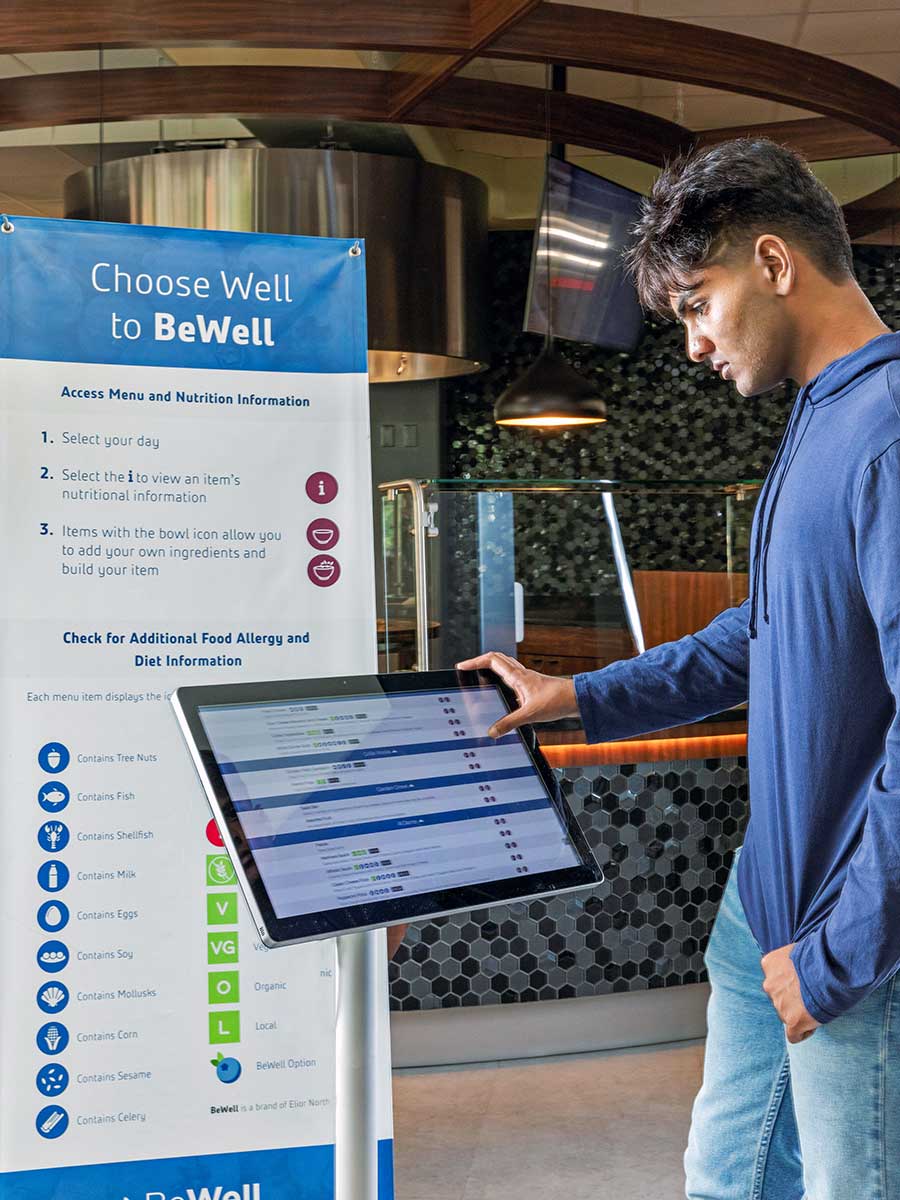 Student at BeWell kiosk